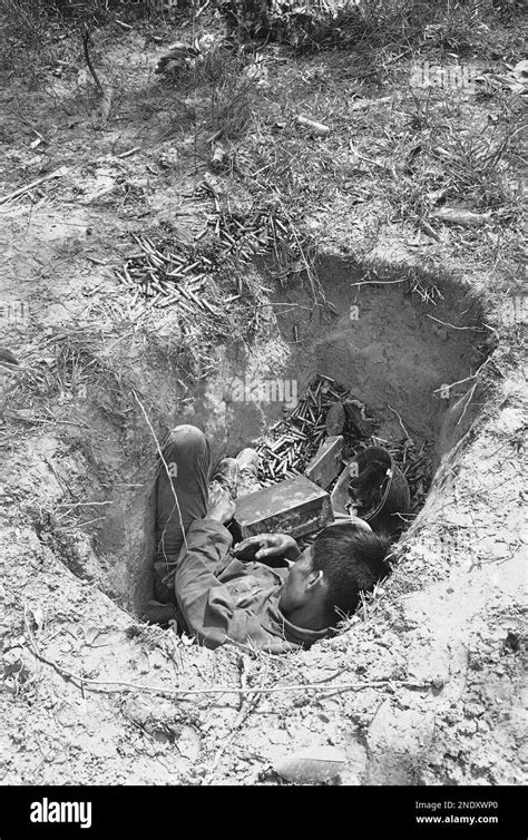 A Vietnamese Machine Gunner Lies Dead In His Foxhole With Hundreds Of