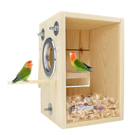 Two Birds Sitting On Top Of A Wooden Box