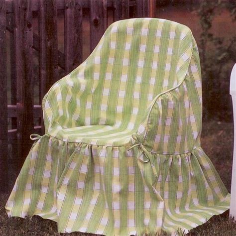 A Green And White Checkered Chair Sitting In The Grass