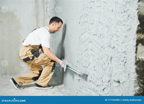 Plasterer Using Screeder Smoothing Putty Plaster Mortar On Wall Stock