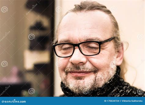 Close Up Portrait Of An Elderly Man Praying Or Dreaming With His Eyes