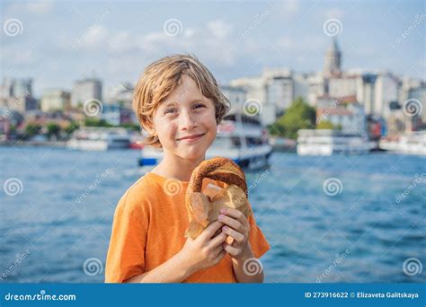 Boy In Istanbul Having Breakfast With Simit And A Glass Of Turkish Tea