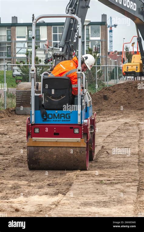 roller operator of a road roller at work on a construction site Stock Photo - Alamy