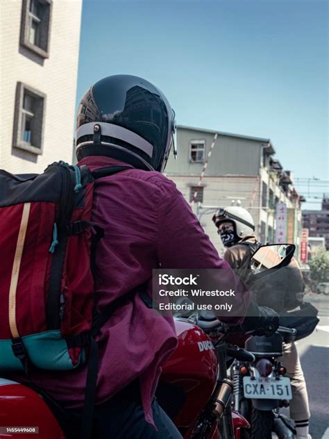 Vertical Shot Of Two Men Riding Motorcycles On An Urban Street In Yilan