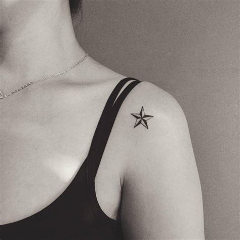 Small nautical star tattoo on the left shoulder.