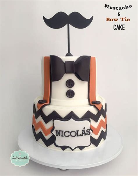 A Cake With A Mustache And Bow Tie On It