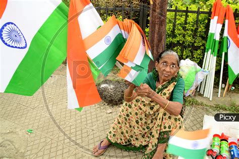 Image Of An Old Woman Selling Indian National Flags Tri Color In