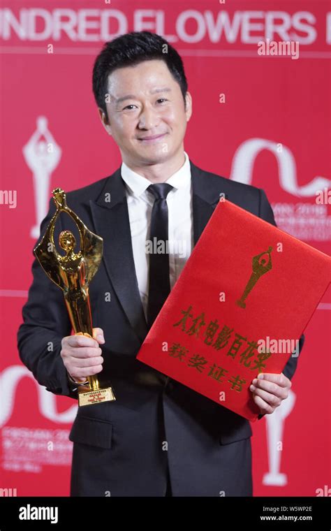 Chinese actor and director Wu Jing poses with his trophy after winning ...