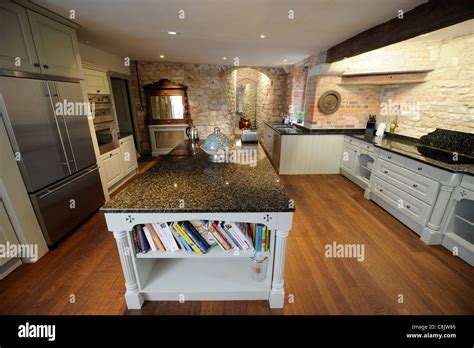 A Kitchen With Modern Appliances And Fittings Within A Historic