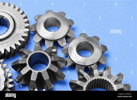 Different Stainless Steel Gears On Light Blue Background Closeup Stock