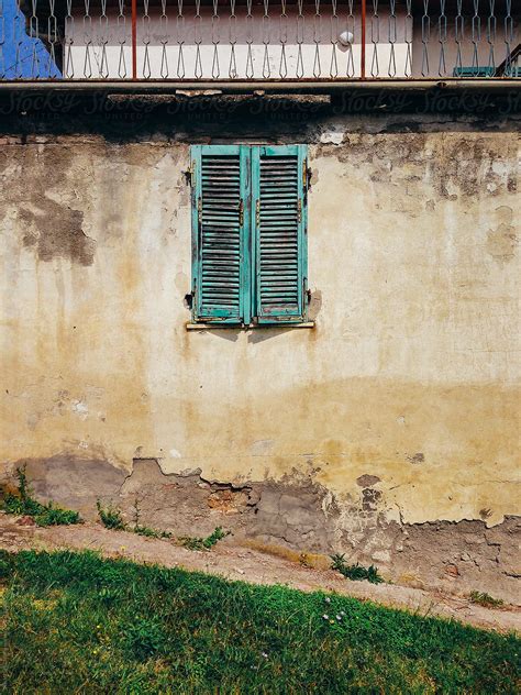 Turquoise Window Shutter In Old Shabby Wall By Stocksy Contributor