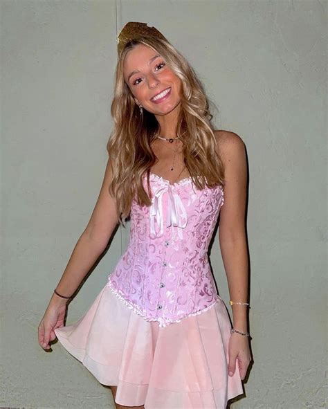 A Woman In A Pink Corset Posing For The Camera