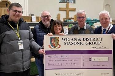 Wigan Masons present charity cheques to those helping the homeless