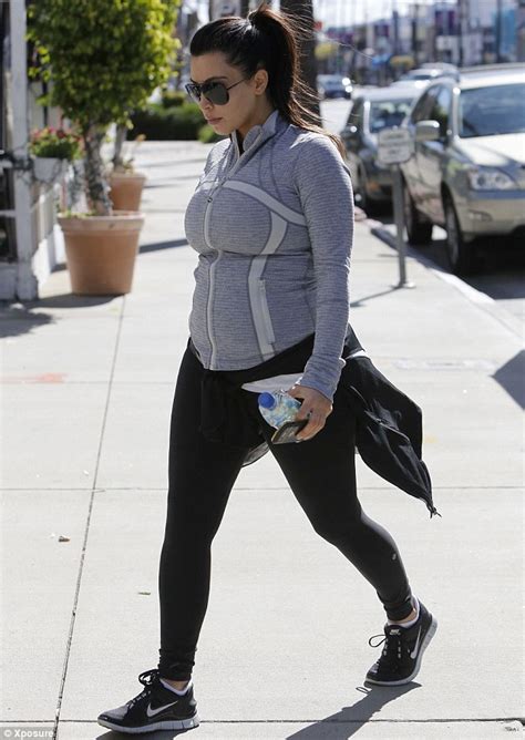 Kim Kardashian Keeps Her Pregnancy Curves Under Wraps As She Heads To