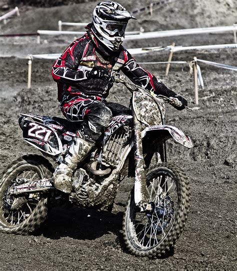 Man In White And Orange Motocross Overall Riding His Motocross Dirt