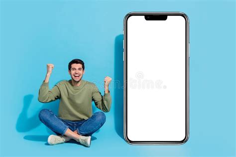 Full Body Portrait Of Delighted Person Sit Floor Raise Fists Celebrate