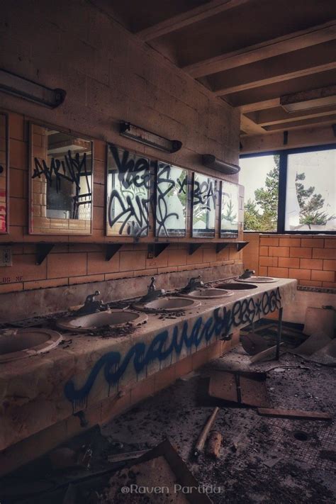 Abandoned Restroom With Graffiti And Sinks