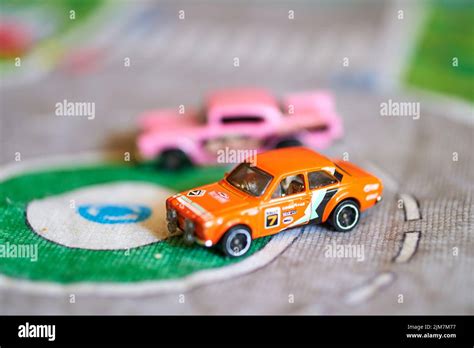 A Selective Focus Of A Mix Of Mattel Hot Wheels Toy Model Cars On A Play Road Mat Stock Photo