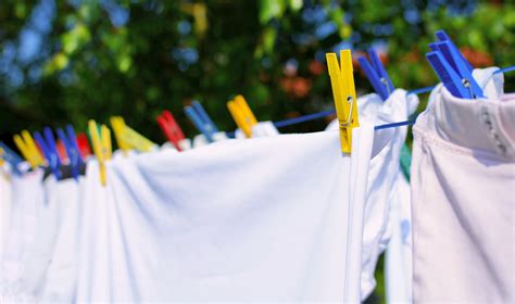 Fresh white laundry hang on the clothesline with colorful pegs. | Skyline Enterprises