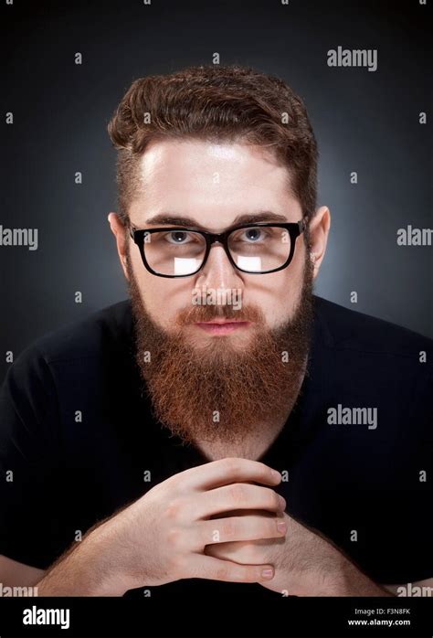 Portrait of a Teenage Hipster with Beard and Glasses Stock Photo - Alamy