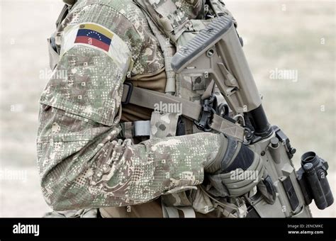 Soldier With Assault Rifle And Flag Of Venezuela On Military Uniform