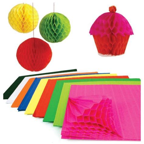 colorful paper lanterns and tissue pom poms hanging from strings on ...