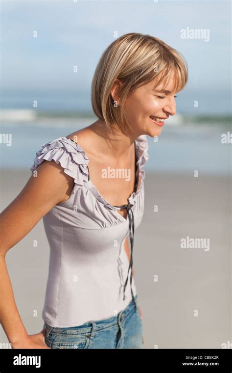 Woman laughing on beach Stock Photo - Alamy