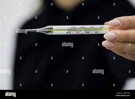 Close Up Mercury Medical Glass Thermometer In Female Hand Which Shows