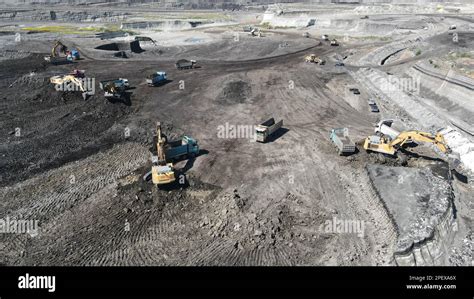 Excavators Working On Huge Mining Site Loading The Trucks Trucks