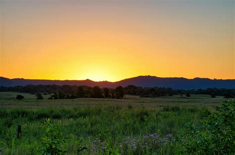 A Grassy Field during Sunset · Free Stock Photo