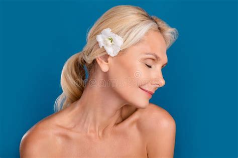 Photo Of Positive Dreamy Elderly Lady Naked Shoulders Enjoying Eustoma