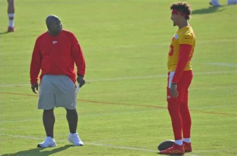 two men standing next to each other on a field