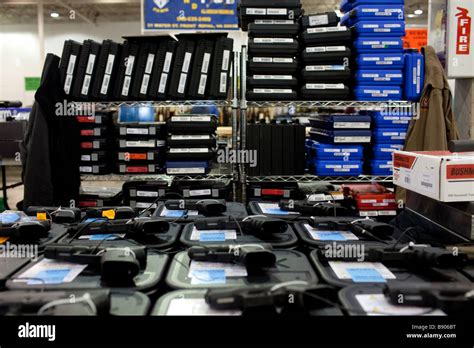 Guns are displayed on a vendors table for sale at a gun show in ...