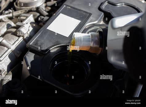 Refueling And Pouring Oil Quality Into The Engine Motor Car