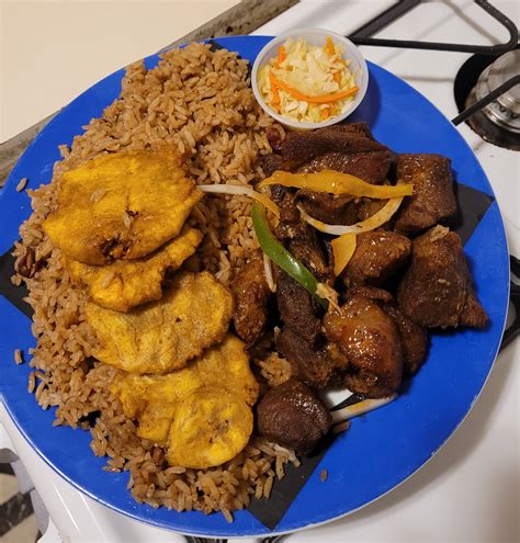 Griyo with Red Beans & rice and tostones. From Kizin Creole/Haitian restaurant in Rogers Park ...