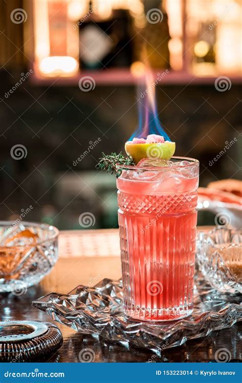 Beautiful Red Cocktail With Ice In Faceted Glass Decorated With