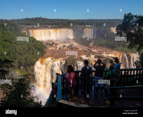 Tourists Admiring The Iguazu Falls One Of The Biggest Falls In The