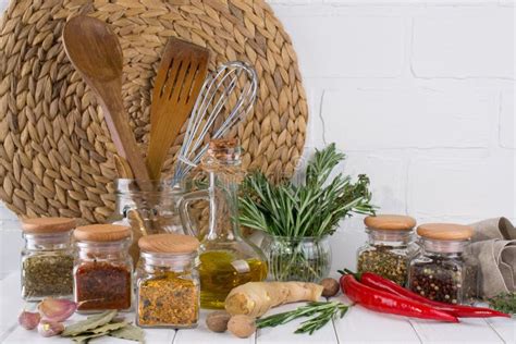 Kitchen Utensils Herbs Colorful Dry Spices In Glass Jars Stock Photo