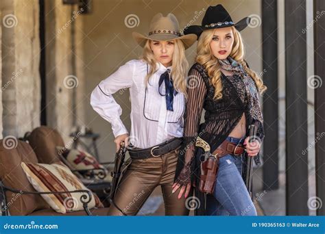 Two Lovely Blonde Models Dressed As Cowgirls Enjoys The American West