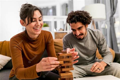 Free Photo Wife And Husband Playing A Wooden Tower Game