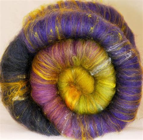 A Purple Yellow And Green Spinning Ball Of Yarn