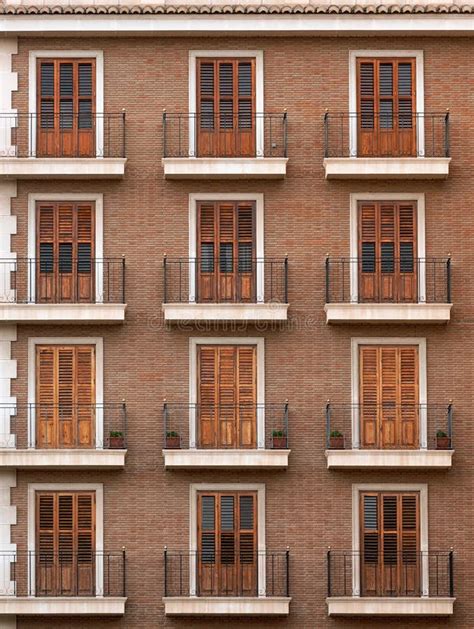 La Fachada De Un Edificio De Ladrillo Con Varias Hileras De Balcones O