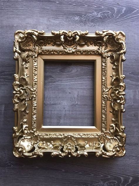 An Ornate Gold Frame On A Wooden Wall