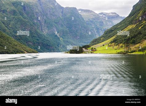 Landscape With Naeroyfjord Mountains And Traditional Village In Norway