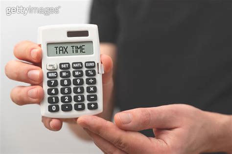 Man Holding Calculator Tax Concept 이미지 2147504061 게티이미지뱅크