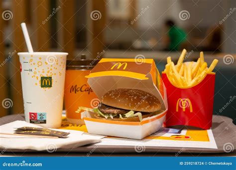 Mcdonald`s French Fries Burger And Drinks On Table Indoors Editorial