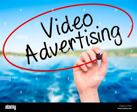 Man Hand Writing Video Advertising With Black Marker On Visual Screen