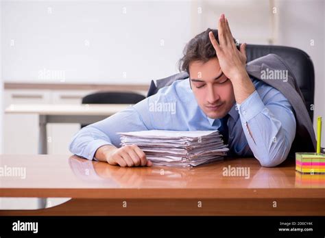 Young employee sleeping in the office Stock Photo - Alamy