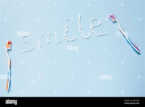 Tooths And The Word Smile Written In White Paint On A Light Blue