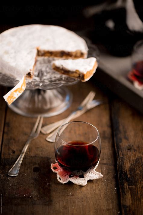 A Glass Of Marsala Wine Served With A Slice Of Panforte By Stocksy